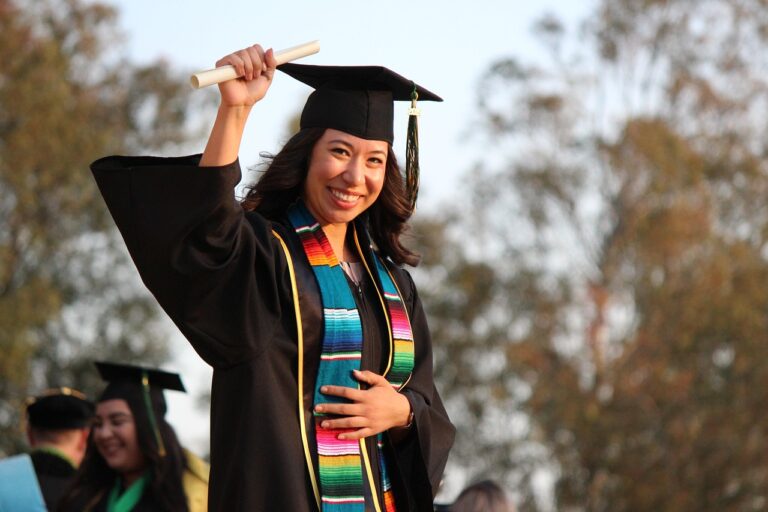 College students celebrating graduation with caps and gowns
