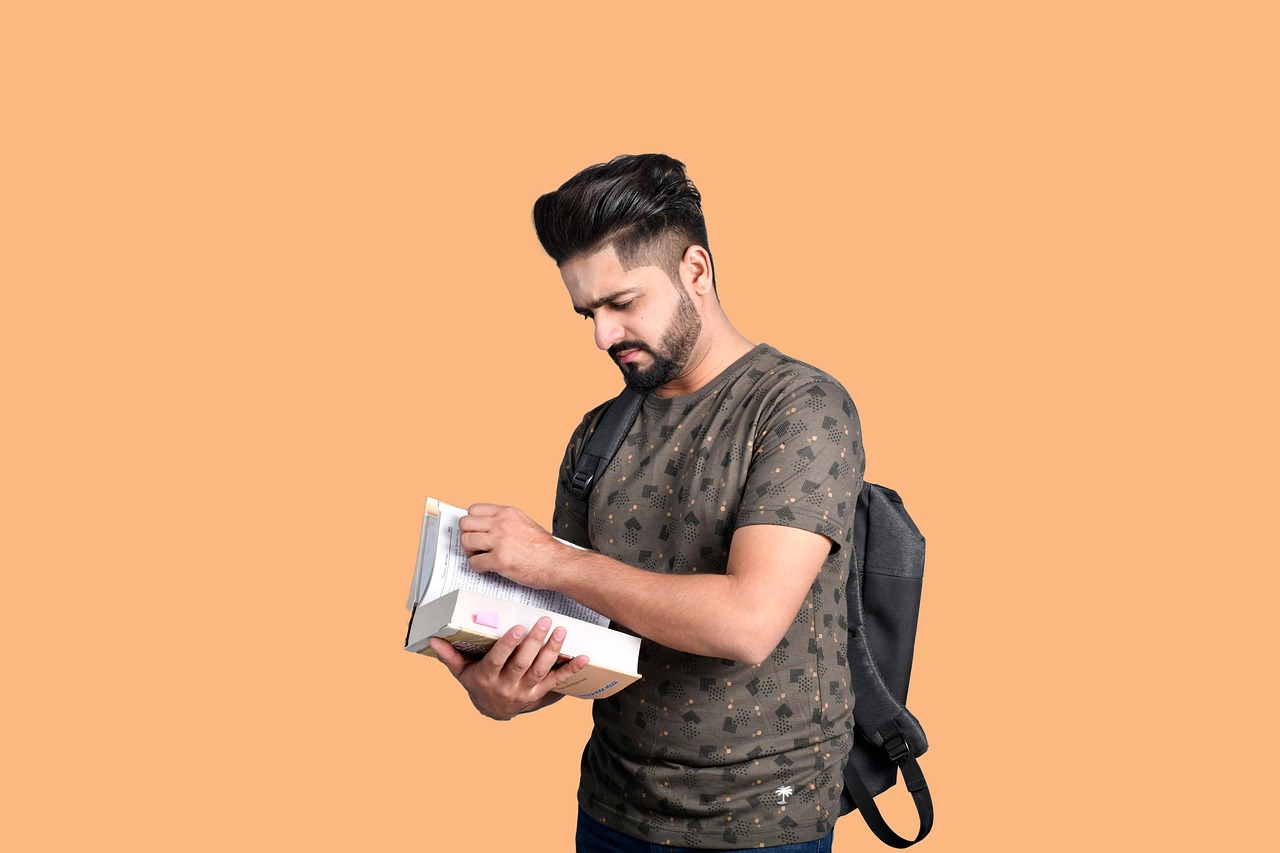 Student studying books to research scholarships for college