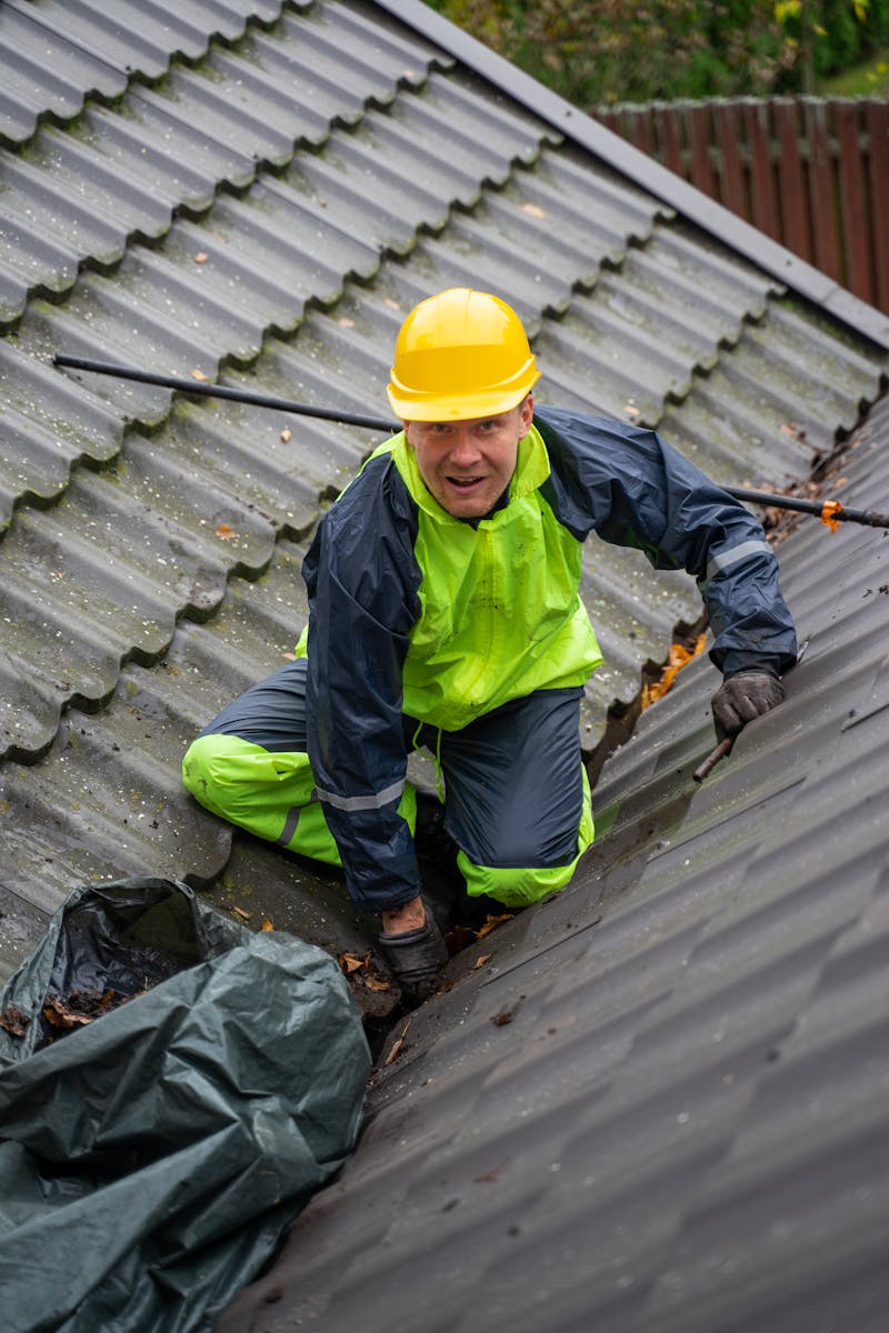 Licensed contractor working safely on a roof