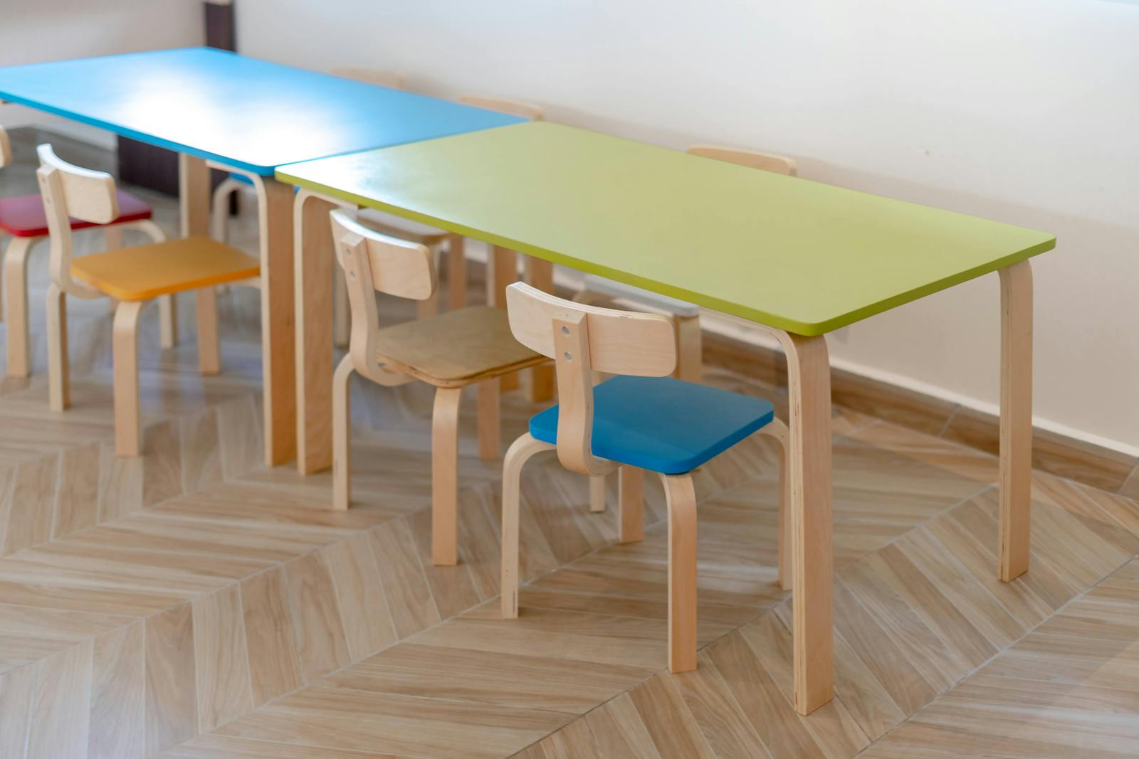 Child-sized chairs and tables in an organized daycare classroom