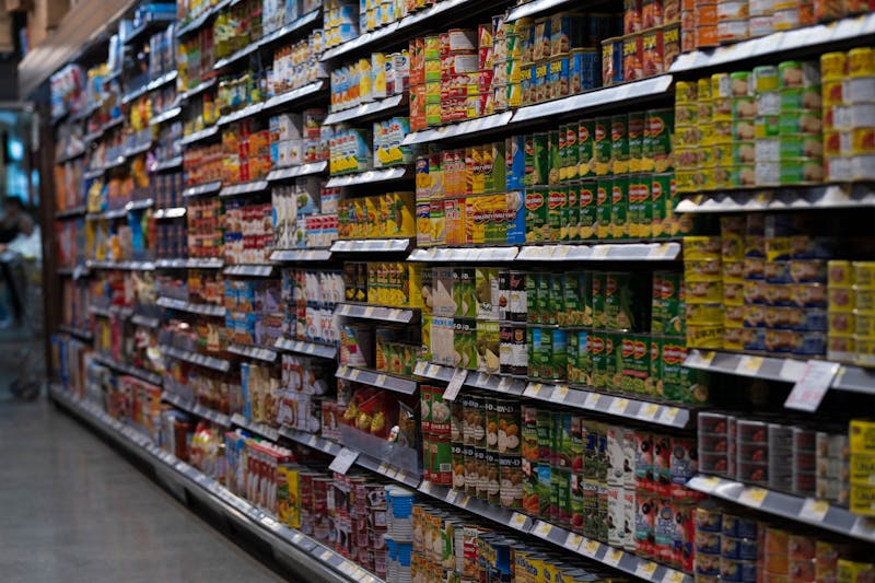 Grocery store aisle with sale signs showing how to save money on groceries
