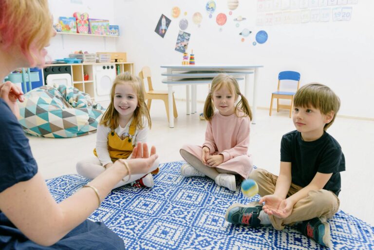 Happy children and teacher enjoying learning activities in a kindergarten daycare