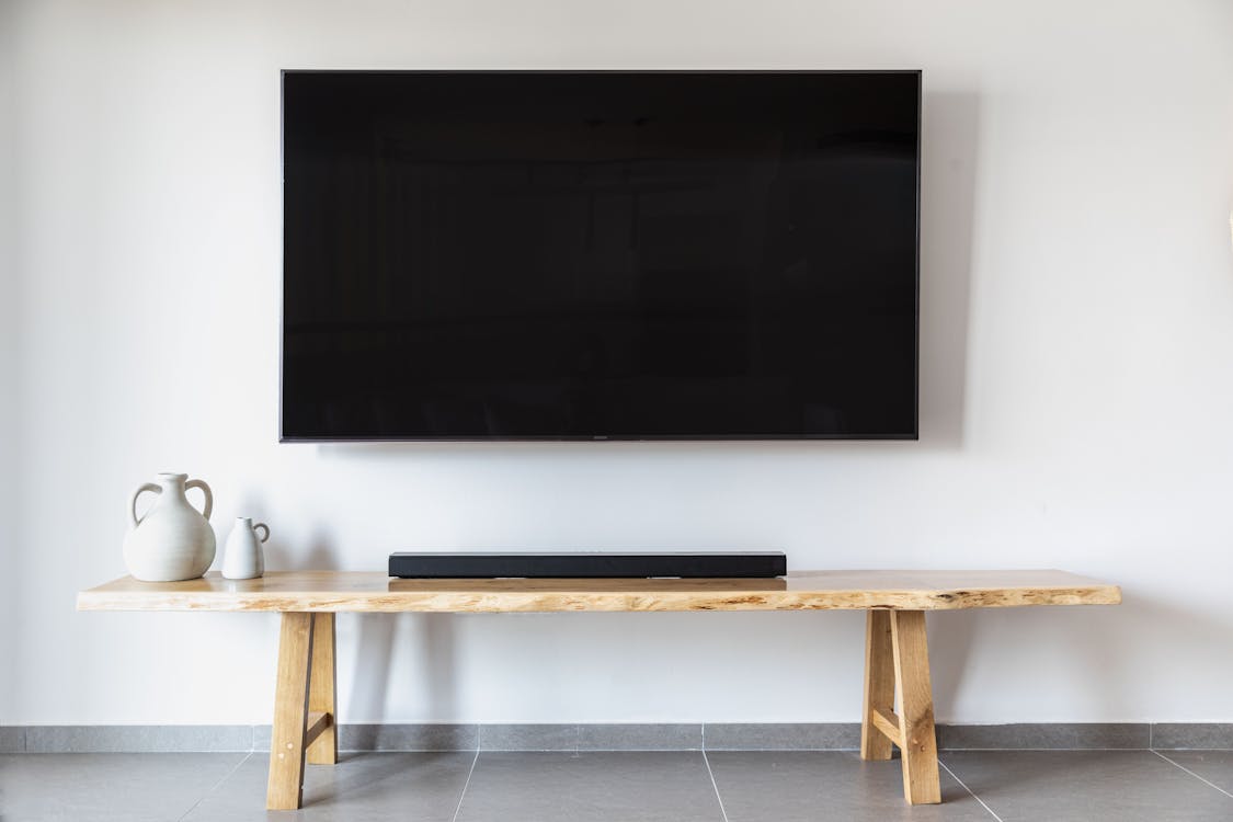 Flat screen TV securely mounted on a wall using wall studs
