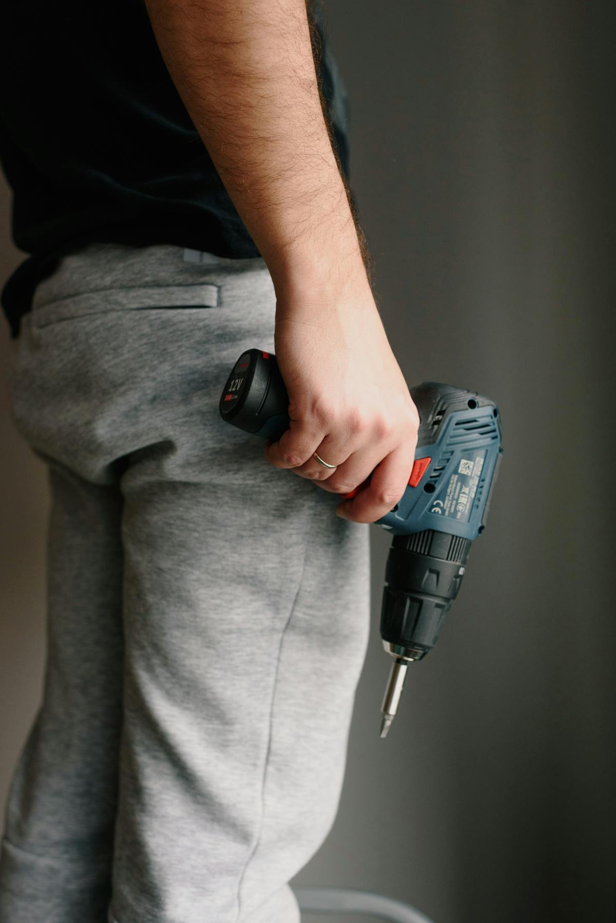 A handyman using an electric drill on a home repair project
